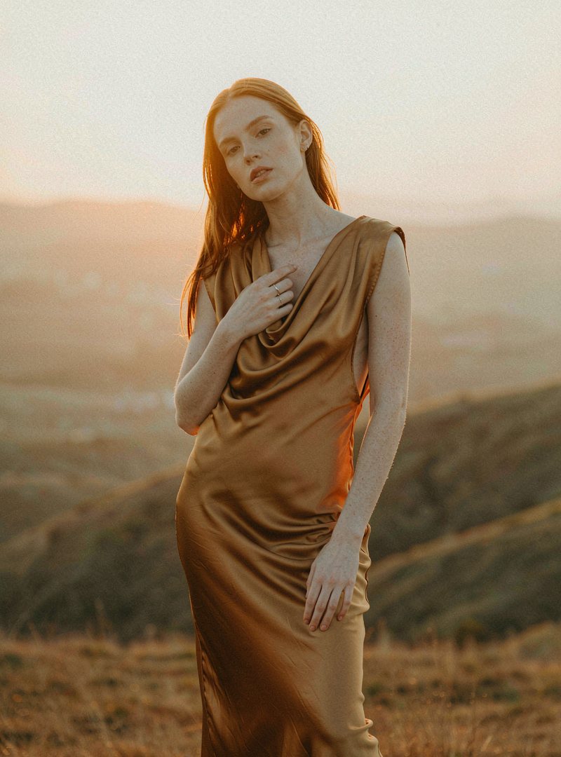 Aster Bias Cut Dress — Amber, modelled outdoors